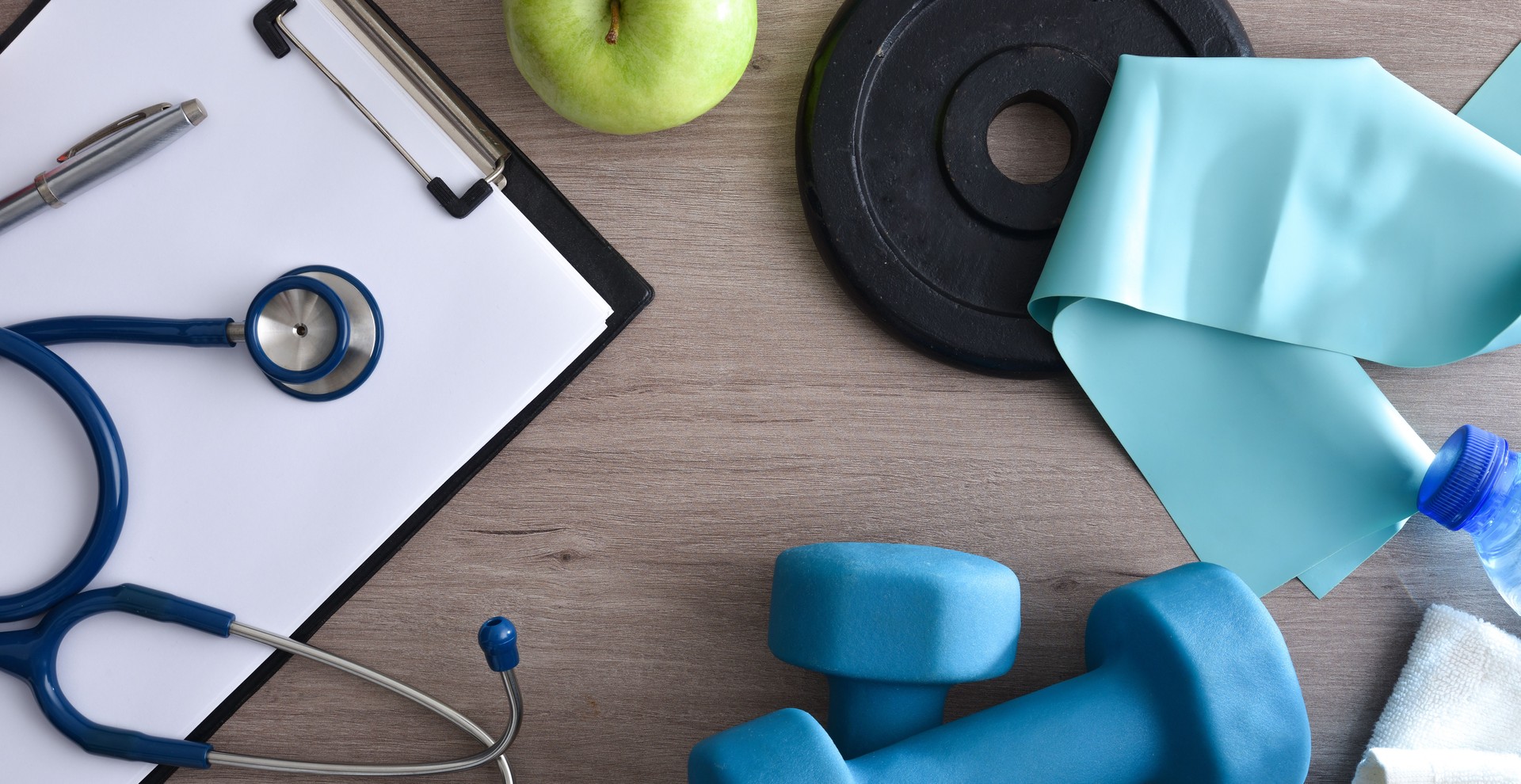 Sports medical technician table with notepad and sports equipment around