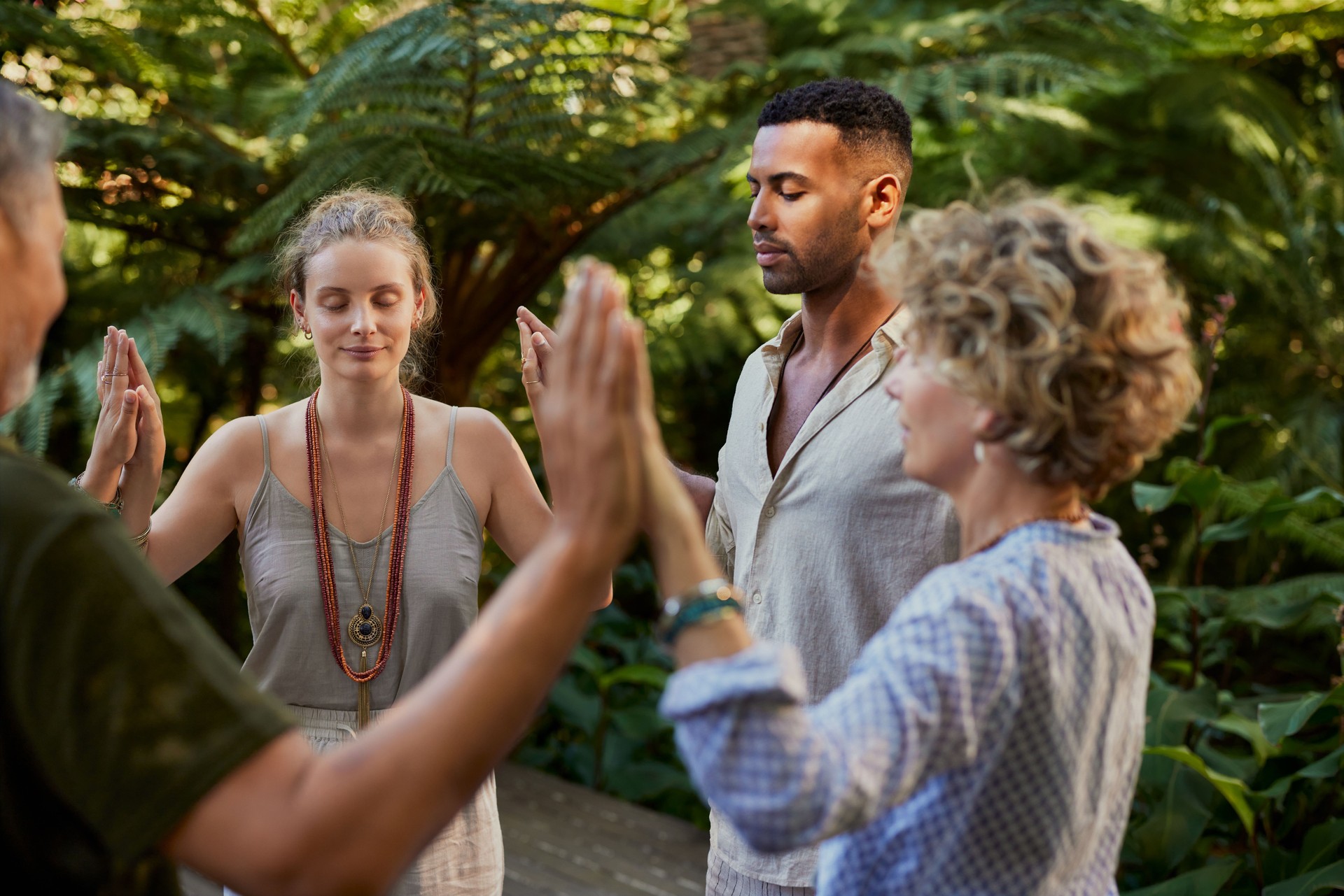 People in circle passing energy and praying together
